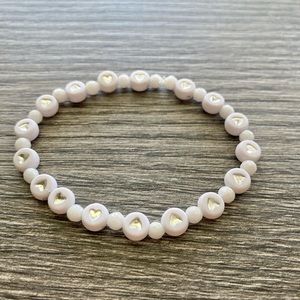 White and silver heart bracelet accented with white jade.  One size